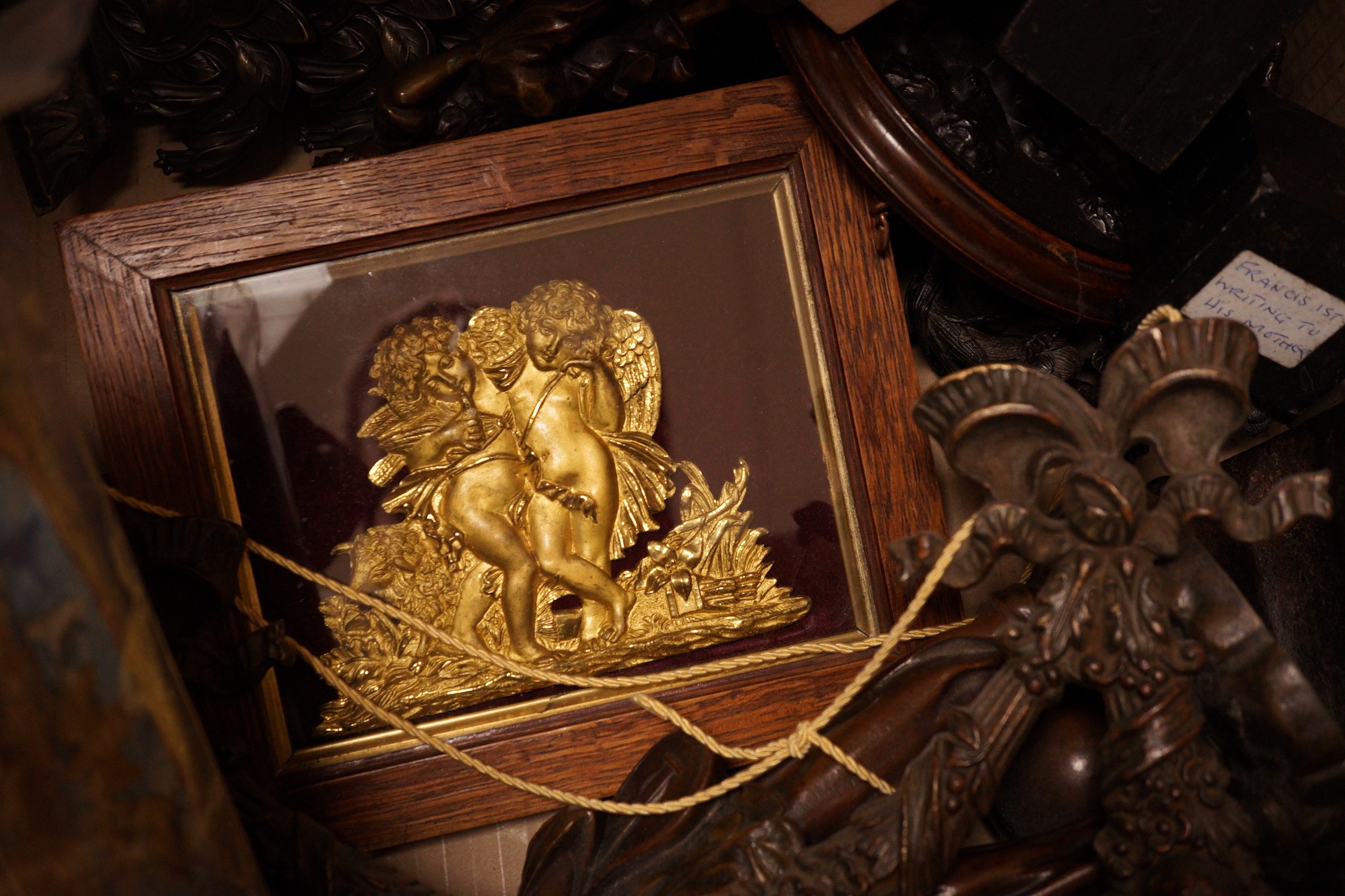 A mixed collection of decorative metalwares, including a gilt brass cherub plaque, a bronze figure of a boy cell signed L Grachner, a spelter figure of a Pierrot etc.